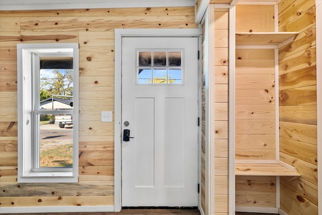 doorway featuring wood walls