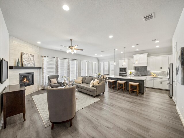 rec room featuring lofted ceiling, light colored carpet, and ceiling fan