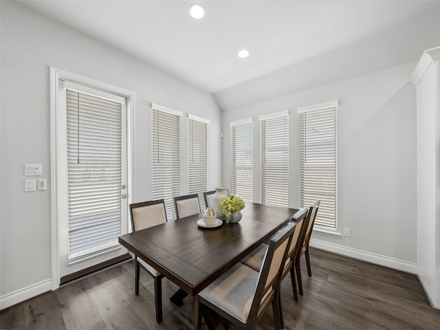 dining space featuring dark wood finished floors, recessed lighting, lofted ceiling, and baseboards