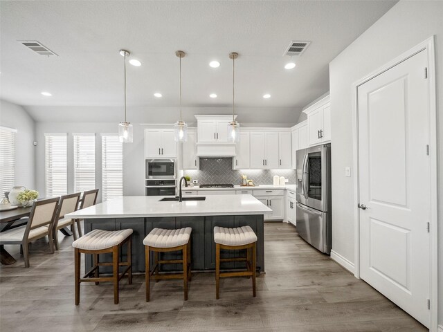 bathroom featuring vanity, tile patterned floors, vaulted ceiling, and separate shower and tub