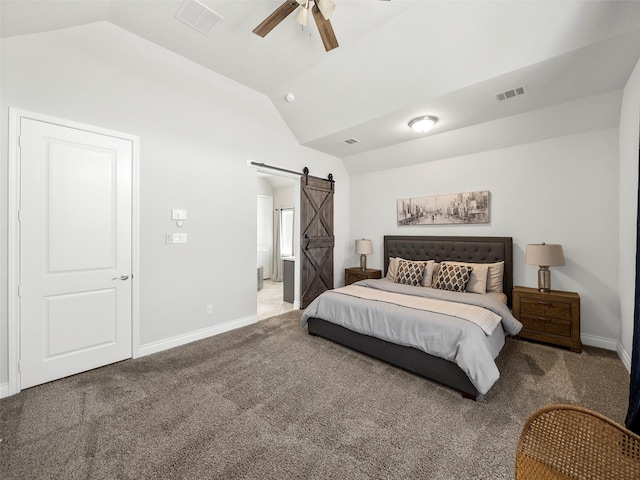 bedroom with a barn door, carpet flooring, visible vents, and lofted ceiling