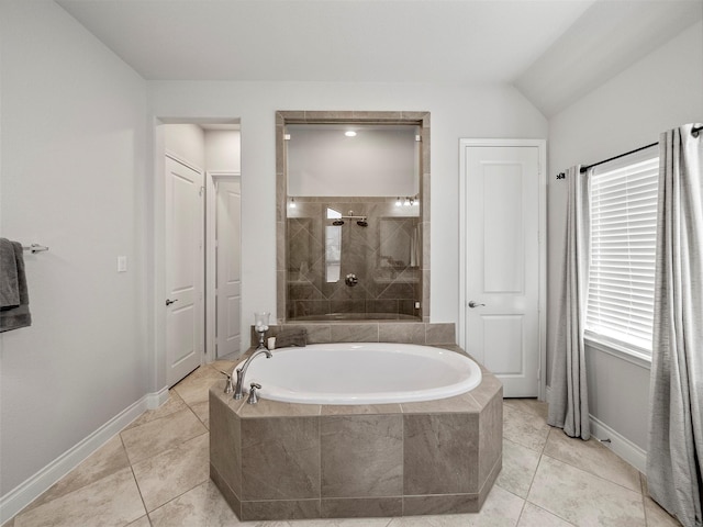 full bath featuring tile patterned flooring, a bath, baseboards, and a tile shower