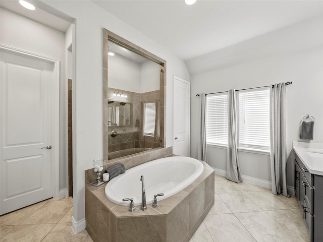 full bath featuring tile patterned floors, a garden tub, a tile shower, vanity, and vaulted ceiling