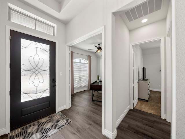 entryway featuring visible vents, baseboards, a ceiling fan, and dark wood-style flooring