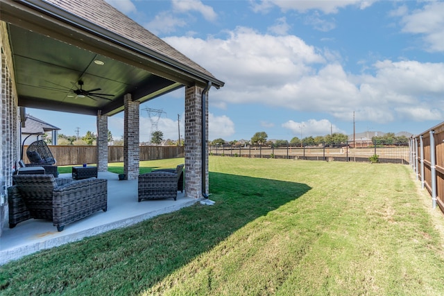 view of yard with ceiling fan and an outdoor living space