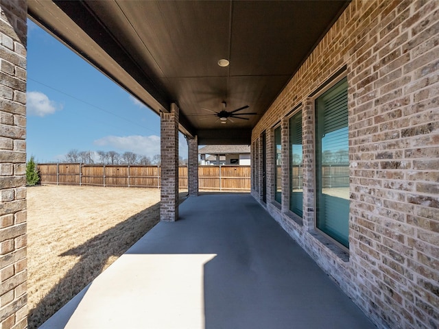 view of patio with a ceiling fan and fence