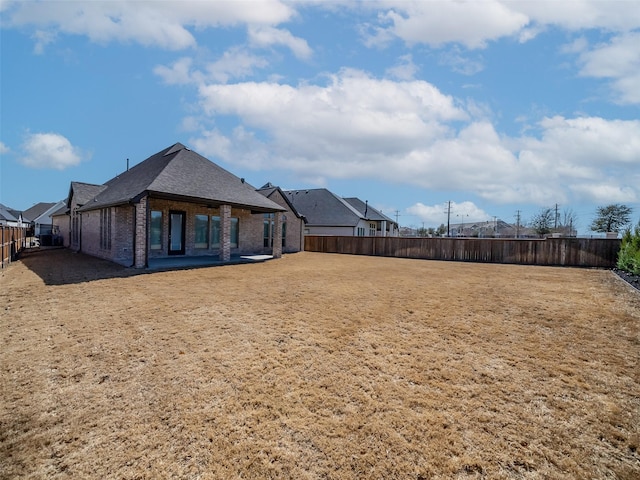 view of yard featuring a residential view and a fenced backyard