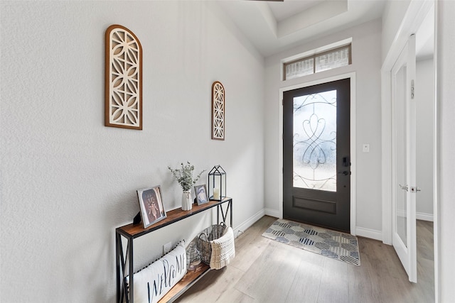 foyer entrance with light hardwood / wood-style floors