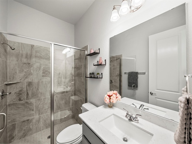 bathroom featuring toilet, a stall shower, and vanity