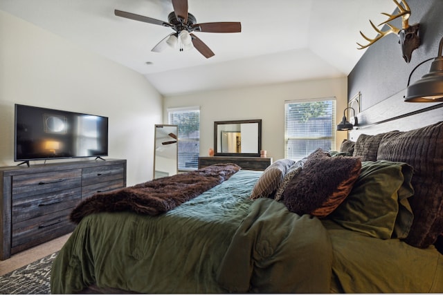 bedroom featuring multiple windows, ceiling fan, carpet, and lofted ceiling