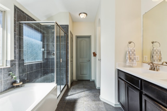 bathroom with tile patterned flooring, vanity, and separate shower and tub