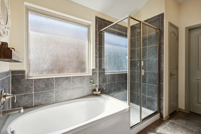 bathroom featuring separate shower and tub, tile patterned flooring, and tile walls