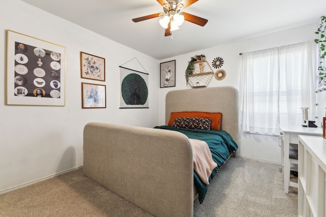 bedroom with ceiling fan and light carpet