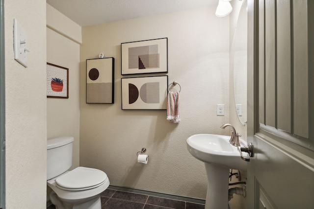 bathroom featuring tile patterned floors and toilet