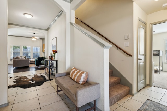 interior space featuring ceiling fan and crown molding