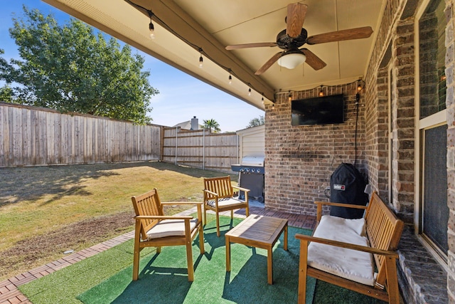 view of patio featuring ceiling fan and a grill