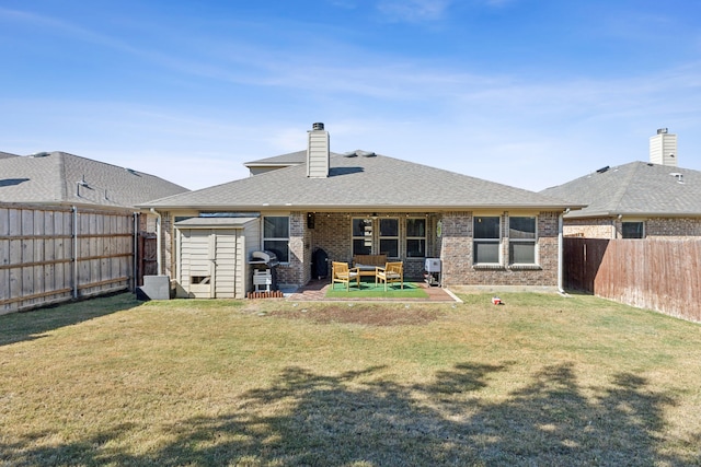 back of house featuring a lawn and a patio