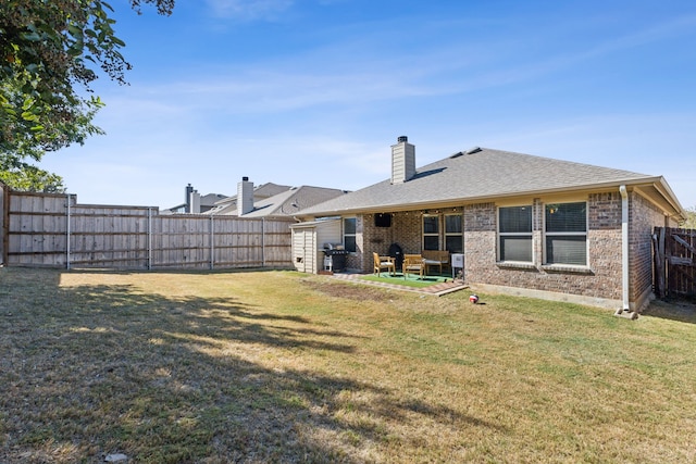 back of house featuring a yard and a patio