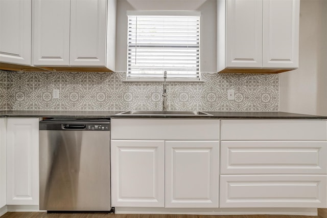 kitchen featuring sink, tasteful backsplash, dishwasher, and white cabinets