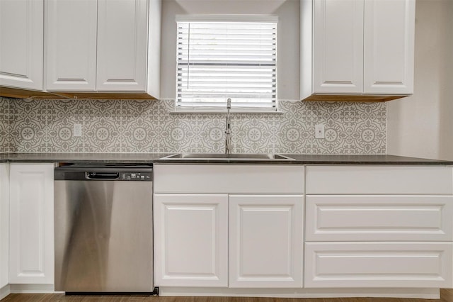 716 SE 7th Ave, Mineral Wells, TX 76067 - kitchen with stainless steel dishwasher, a sink, dark countertops, and white cabinetry