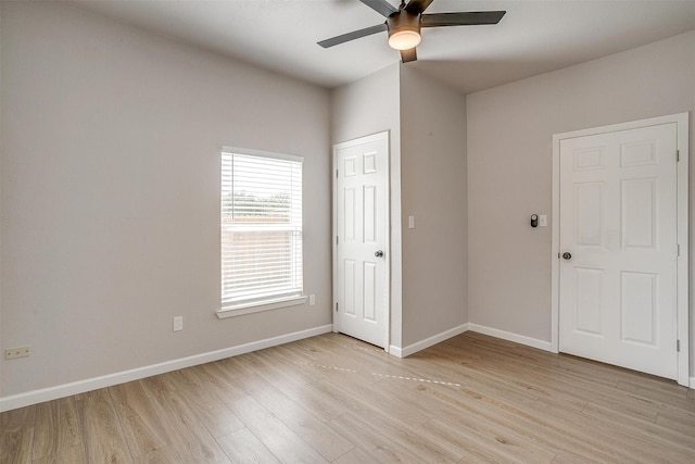 716 SE 7th Ave, Mineral Wells, TX 76067 - unfurnished bedroom with light wood-style flooring, baseboards, and a ceiling fan