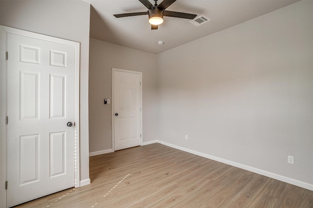 spare room featuring light hardwood / wood-style flooring and ceiling fan