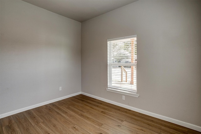 unfurnished room with light wood-type flooring