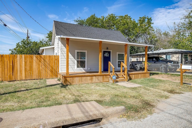 view of front of home with covered porch and a front lawn