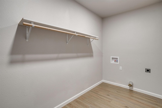 washroom with hookup for an electric dryer, hookup for a washing machine, and light wood-type flooring