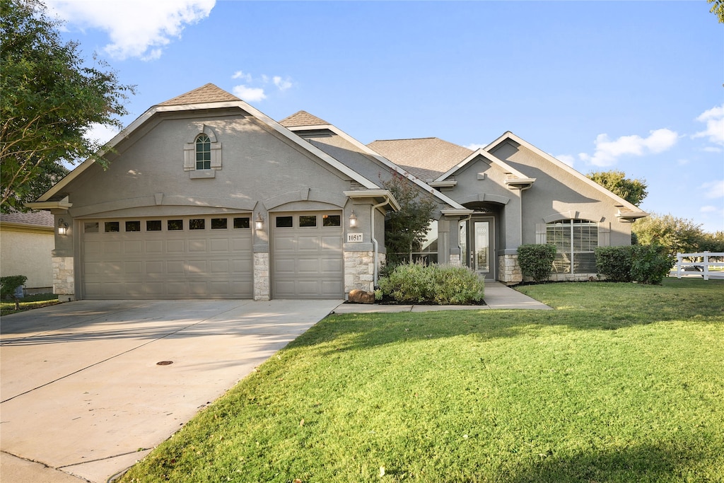 view of front of home featuring a garage and a front lawn