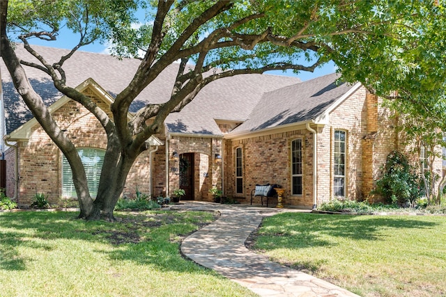 tudor-style house with a front lawn