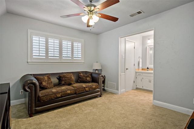 sitting room with vaulted ceiling, light carpet, and ceiling fan