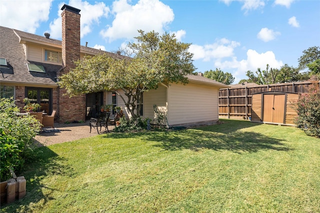 view of yard with a storage shed and a patio area