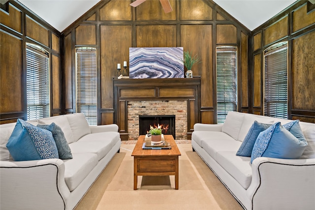 living room with high vaulted ceiling, a brick fireplace, and wooden walls