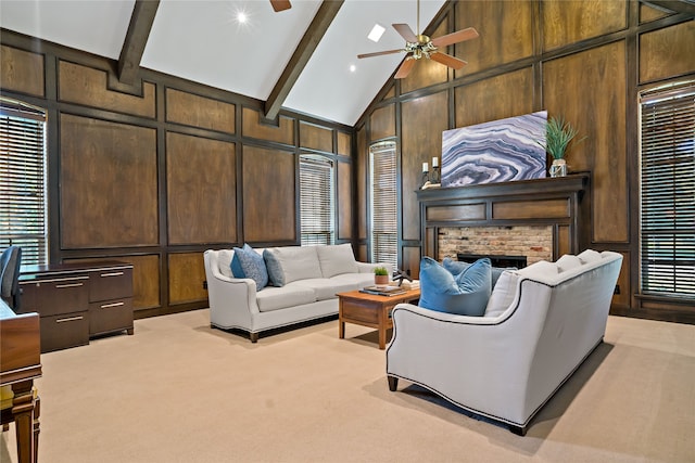 living room featuring beam ceiling, a brick fireplace, light colored carpet, high vaulted ceiling, and ceiling fan