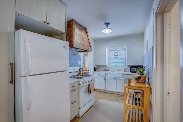 kitchen featuring custom exhaust hood, white appliances, light parquet floors, sink, and white cabinetry