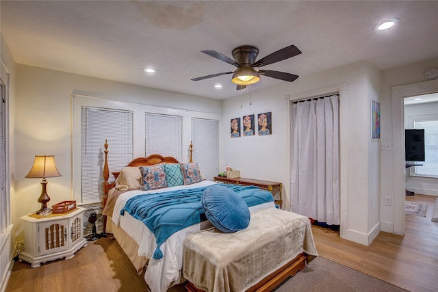 bedroom with ceiling fan and light wood-type flooring