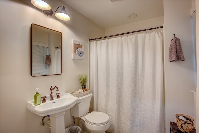 bathroom featuring walk in shower and toilet