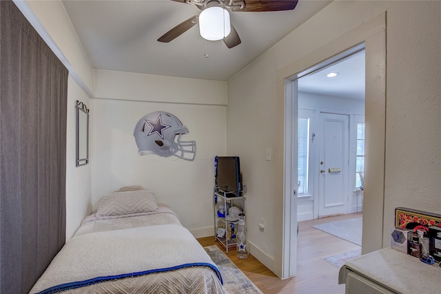 bedroom with light wood-type flooring and ceiling fan