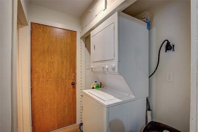 washroom with stacked washer / dryer