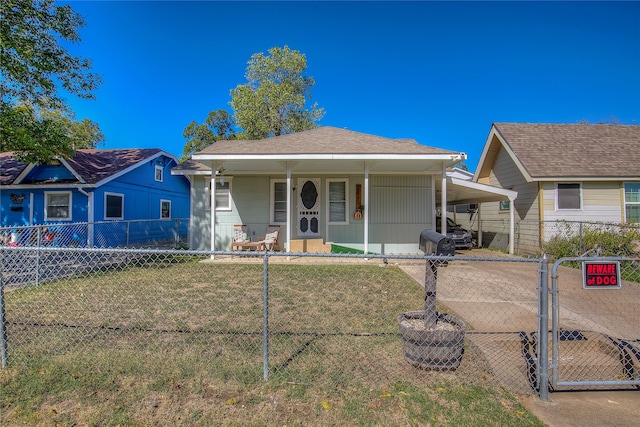 bungalow-style home with covered porch and a front lawn