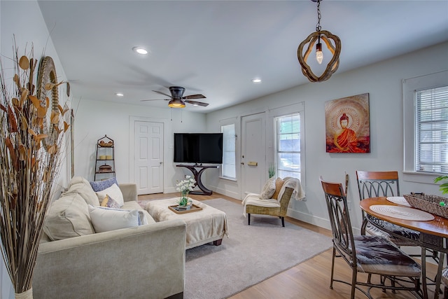 living room with hardwood / wood-style flooring and ceiling fan