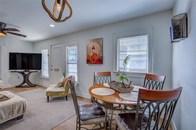 dining space featuring ceiling fan, a wealth of natural light, and light hardwood / wood-style flooring