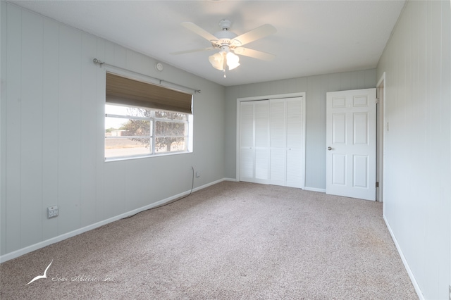 unfurnished bedroom with carpet, a closet, and ceiling fan