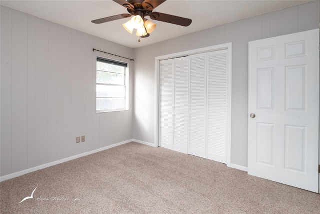 unfurnished bedroom featuring a closet, ceiling fan, and carpet