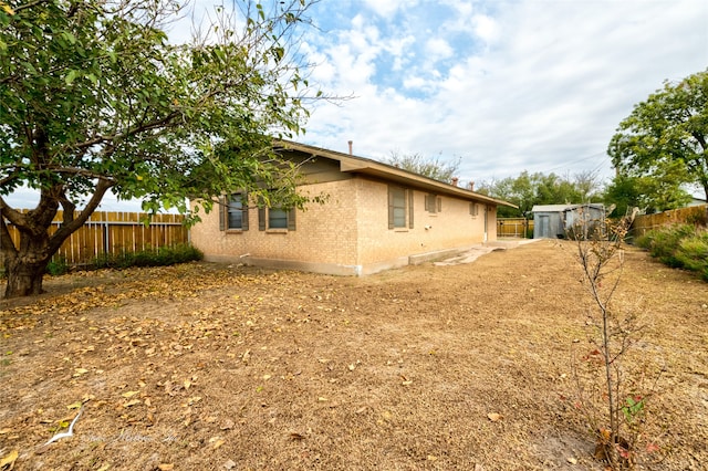 view of property exterior with a storage shed