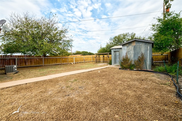 view of yard featuring a shed and central AC unit