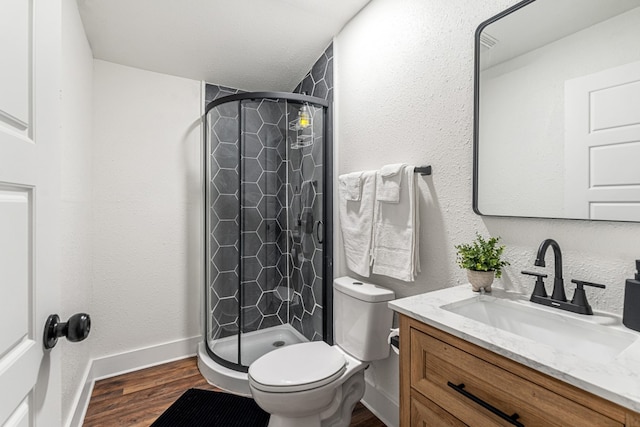110 Fawn Trl, Mabank, TX 75156 - full bathroom featuring a stall shower, wood finished floors, toilet, vanity, and baseboards