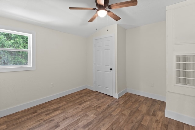 spare room featuring lofted ceiling, dark hardwood / wood-style floors, and ceiling fan