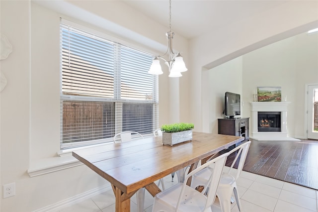 dining area featuring an inviting chandelier and light wood-type flooring